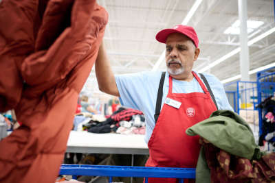 Thrift store worker sorts through donations